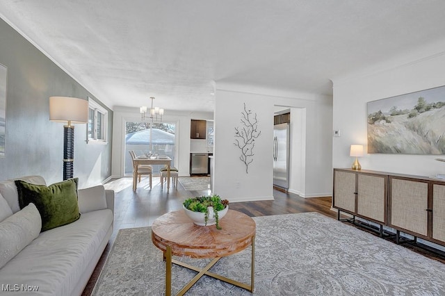 living room with hardwood / wood-style floors and an inviting chandelier