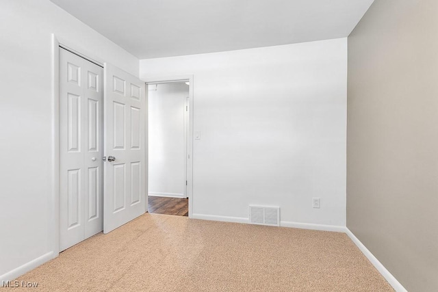 unfurnished bedroom featuring a closet and carpet floors