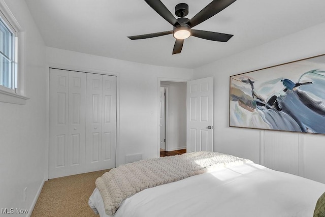 carpeted bedroom with a closet and ceiling fan