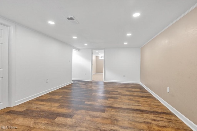 spare room with dark wood-type flooring and ornamental molding