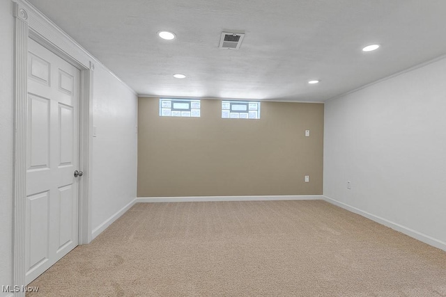 basement featuring light colored carpet