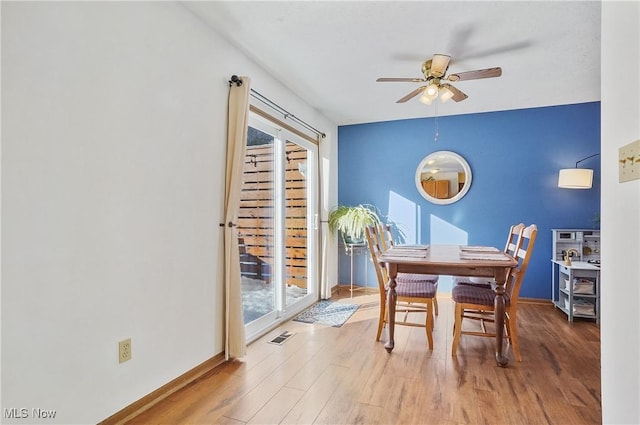 dining space featuring hardwood / wood-style flooring and ceiling fan