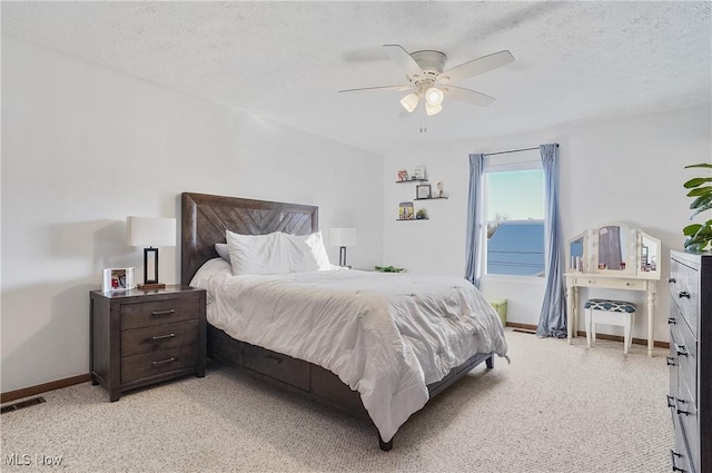 bedroom with a textured ceiling and ceiling fan