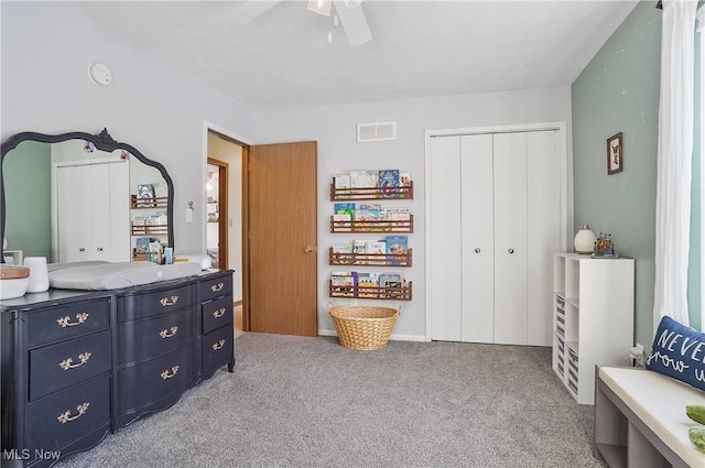 carpeted bedroom with ceiling fan and a closet