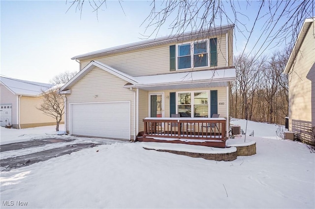 view of property with a garage and covered porch