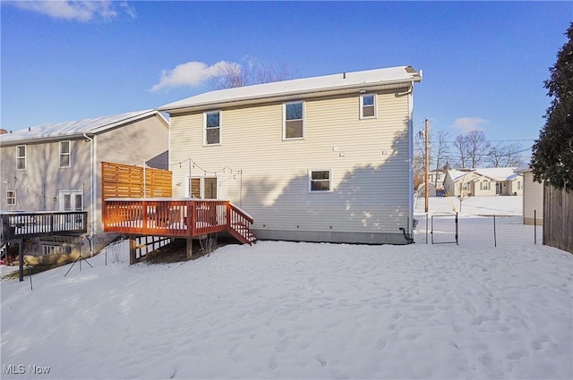 snow covered property with a wooden deck