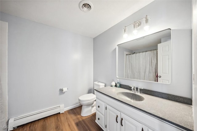 bathroom featuring toilet, curtained shower, a baseboard heating unit, wood-type flooring, and vanity