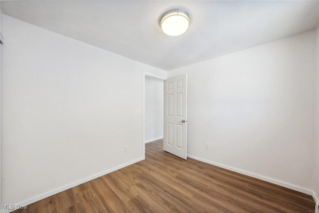 empty room with hardwood / wood-style flooring