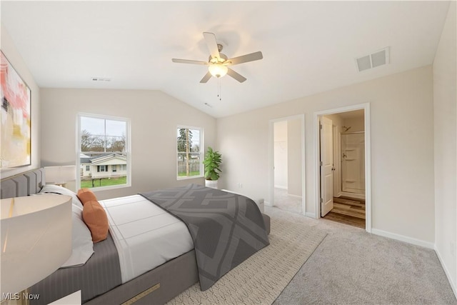 carpeted bedroom with ceiling fan, connected bathroom, and lofted ceiling