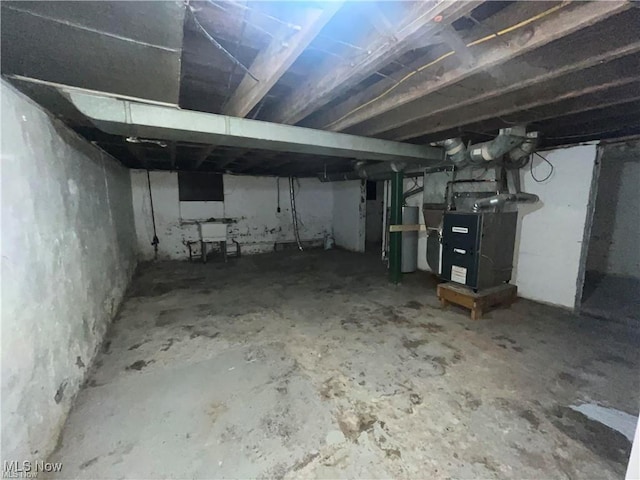 basement with sink and heating unit