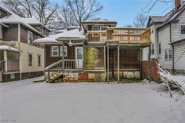 snow covered property featuring a wooden deck