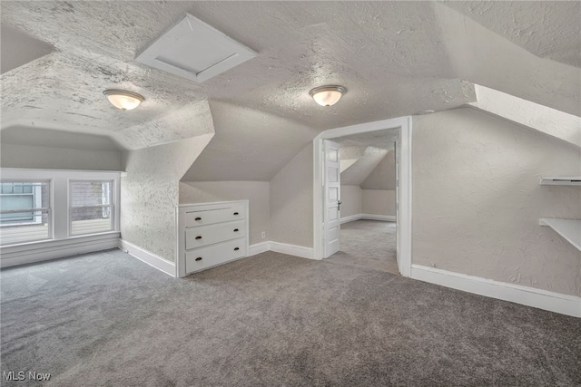 bonus room featuring a textured ceiling, carpet, and vaulted ceiling