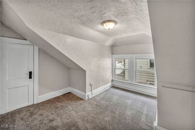 bonus room featuring a textured ceiling, vaulted ceiling, and carpet flooring