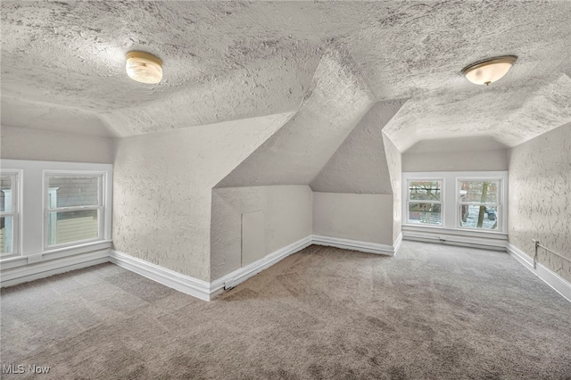 bonus room with lofted ceiling, a textured ceiling, and carpet floors