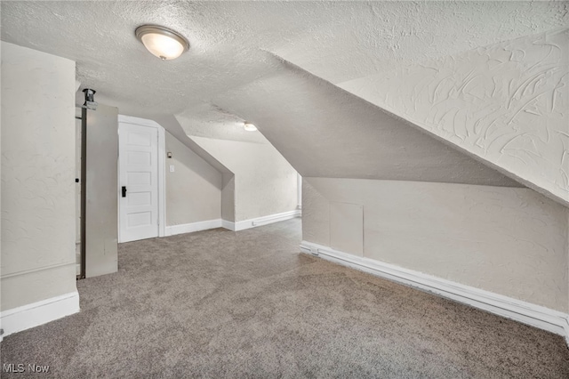 bonus room with lofted ceiling, a textured ceiling, and carpet floors