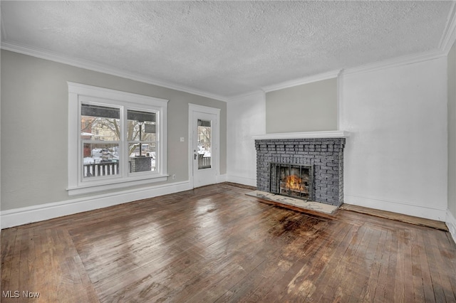 unfurnished living room featuring a fireplace, hardwood / wood-style flooring, and crown molding