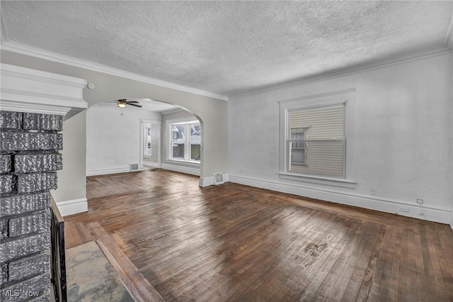 unfurnished living room with a textured ceiling, hardwood / wood-style floors, ceiling fan, and crown molding