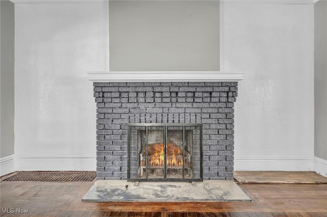 interior details with a brick fireplace