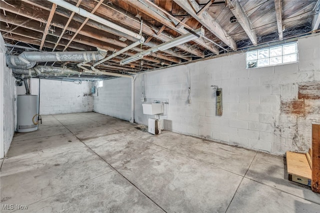 basement featuring gas water heater and sink