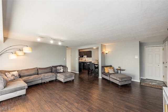 living room with dark hardwood / wood-style flooring and a textured ceiling