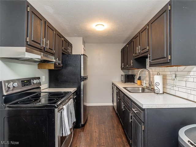 kitchen featuring electric range, dark brown cabinetry, dark hardwood / wood-style floors, and sink