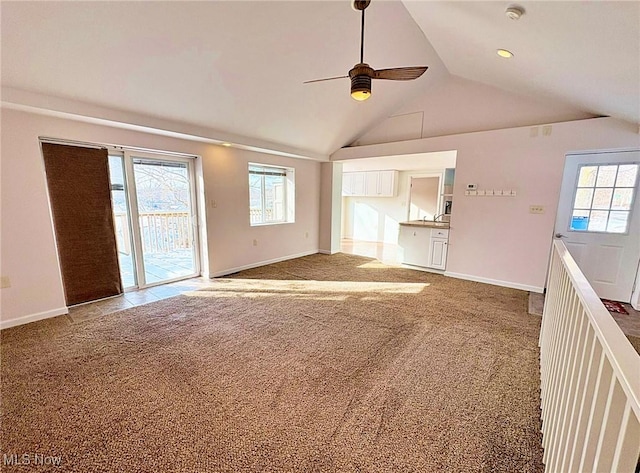 unfurnished living room with lofted ceiling, carpet flooring, and ceiling fan