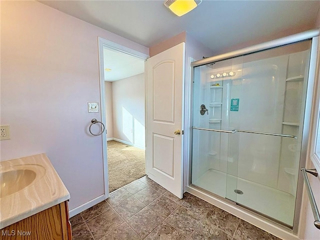 bathroom with a shower with door and vanity