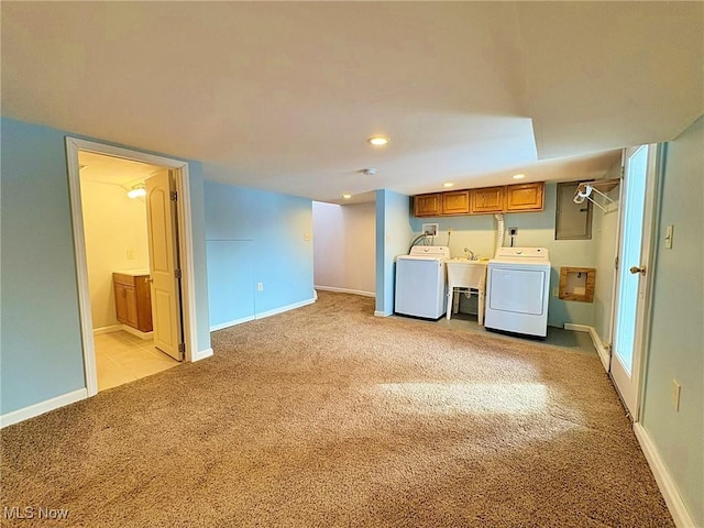 laundry room with washer and dryer, cabinets, light carpet, and sink