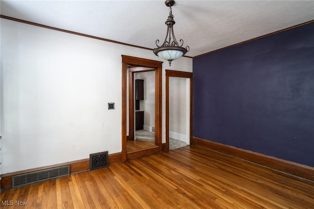 empty room with hardwood / wood-style flooring