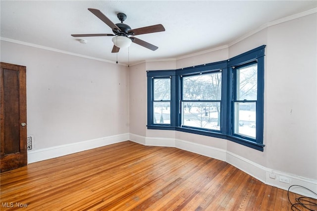 unfurnished room featuring wood-type flooring, ceiling fan, and crown molding