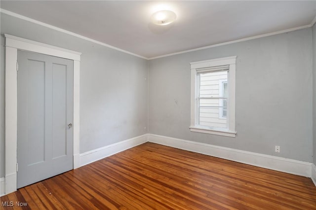 unfurnished room with hardwood / wood-style flooring and crown molding