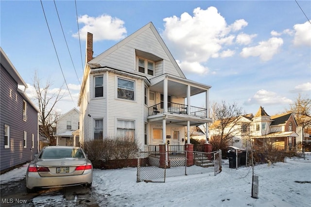 view of front of property with a porch and a balcony