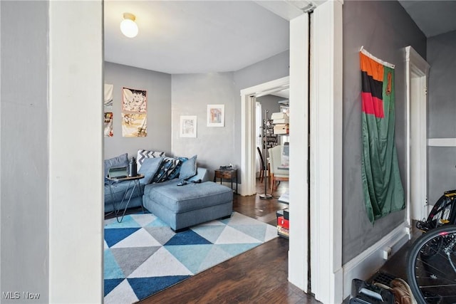 living room with dark hardwood / wood-style flooring