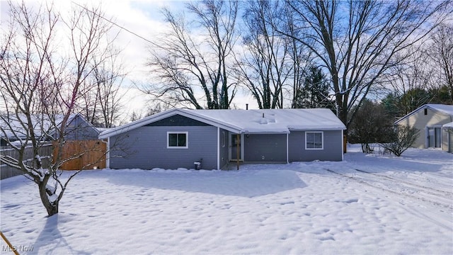 view of snow covered back of property