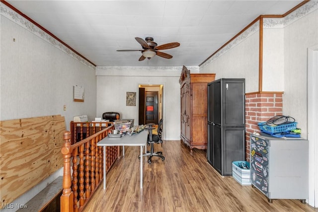 interior space featuring ornamental molding, ceiling fan, and wood-type flooring