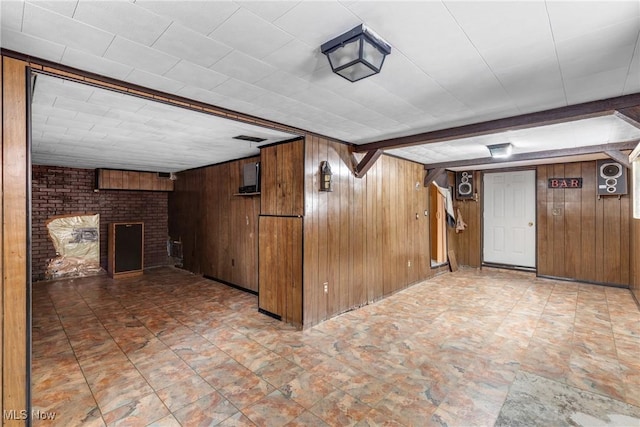 interior space featuring wooden walls and a fireplace