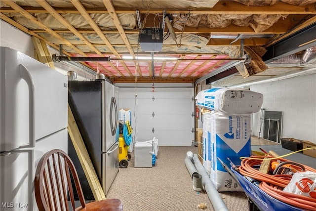 garage featuring a garage door opener, white fridge, and stainless steel fridge