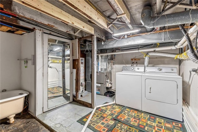 basement with water heater and washing machine and clothes dryer