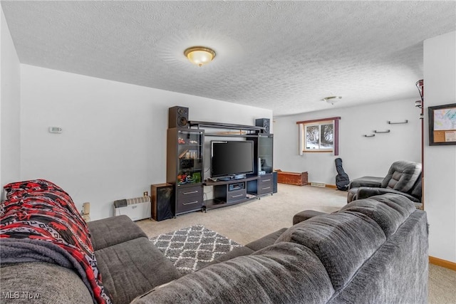 living room with a textured ceiling and light carpet