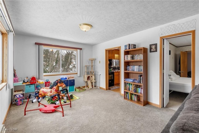 game room featuring a textured ceiling and carpet floors