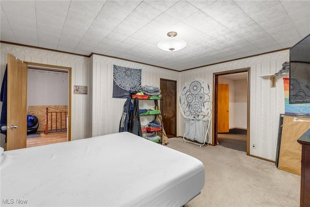 bedroom featuring carpet floors and crown molding