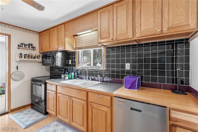 kitchen featuring ceiling fan, black appliances, decorative backsplash, and sink