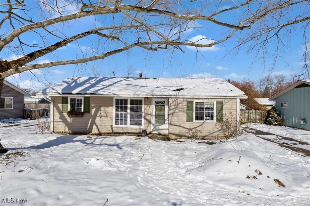 ranch-style home with fence