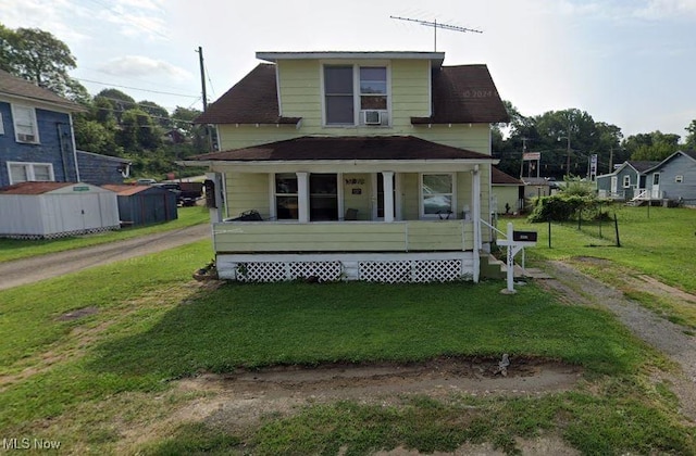 view of front of property featuring a front yard, covered porch, and cooling unit