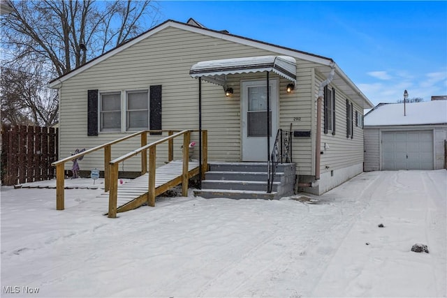 view of front of home with a garage and an outdoor structure