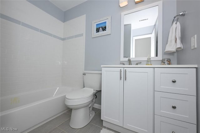 full bathroom with toilet, tiled shower / bath combo, tile patterned flooring, and vanity