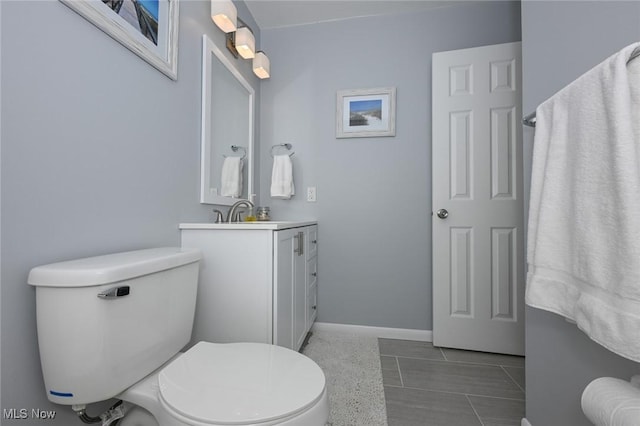 bathroom featuring tile patterned floors, vanity, and toilet