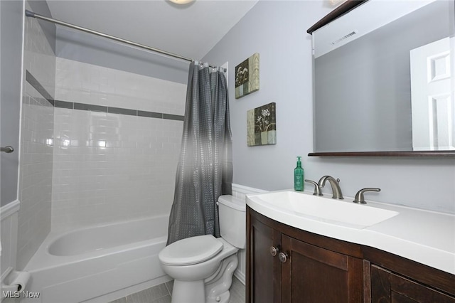 full bathroom featuring toilet, tile patterned flooring, shower / tub combo with curtain, and vanity