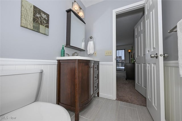 bathroom featuring toilet, vanity, and tile patterned flooring