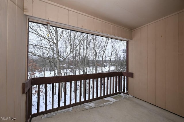 view of snow covered back of property